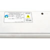 Metal DC power supply with screw terminals on the right and a warning label on top; used to power electronic devices.