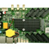 Green single-board computer board with multiple header connectors, a central black heatsink, and a yellow coin-cell battery surrounded by USB/port components