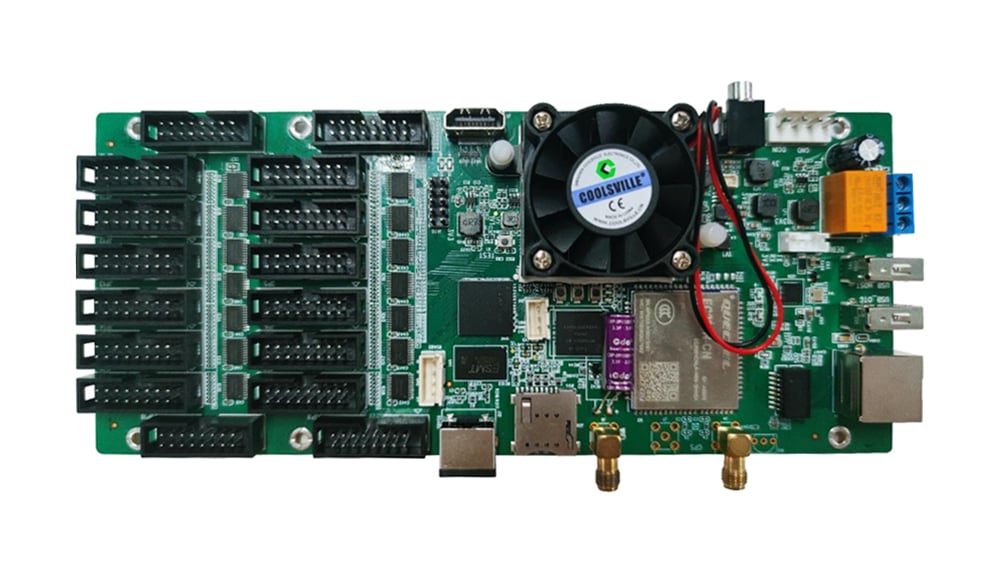 Green control board with numerous connector sockets on the left, a central cooling fan, and various chips around the bottom.