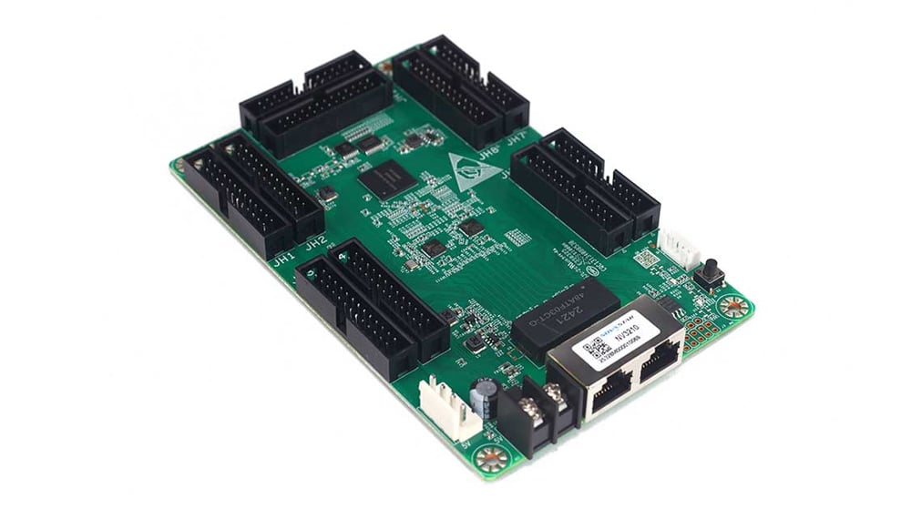 Green development board with six 40-pin header sockets around the edges, an Ethernet port, USB and power connectors, and surface-mounted chips.