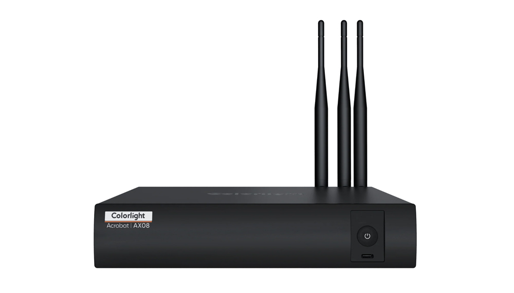 Black wireless router with three tall external antennas on top and a power button on the front panel